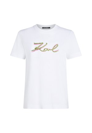 White cotton t-shirt featuring "Karl" in green and pink sequined script. Short sleeves and a crew neckline. Clean, simple design.