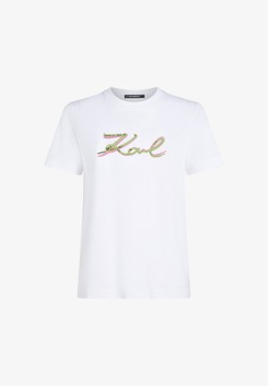 T-shirt en coton blanc avec "Karl" en script de sequins verts et roses. Manches courtes et col rond. Design propre et simple.