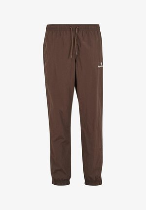 Brown lightweight casual pants with elastic waistband, drawstring, side pockets, elastic cuffs, and small white logo on upper thigh.