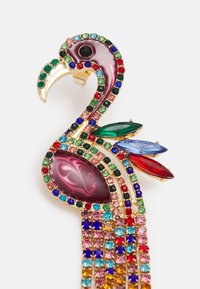 Colorful flamingo brooch featuring gold-tone hardware, embellished with multi-colored gemstones and a marbled pink body design.