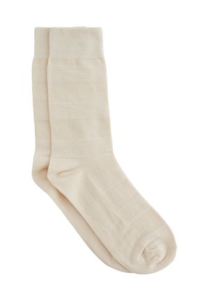 Beige Baumwollsocken mit gerippter Textur und horizontalen Streifen, verstärkt an Zehen und Bündchen für zusätzliche Haltbarkeit.