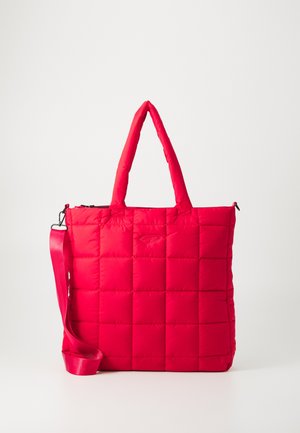 Padded red tote bag with a quilted design, rectangular shape, two top handles, and a detachable shoulder strap. Zipper closure along the top.
