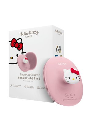 Brosse pour le visage rose sur le thème Hello Kitty avec poils en silicone, détail nœud rouge et emballage mettant en avant un nettoyage en profondeur 3-en-1 guidé par SmartApp.