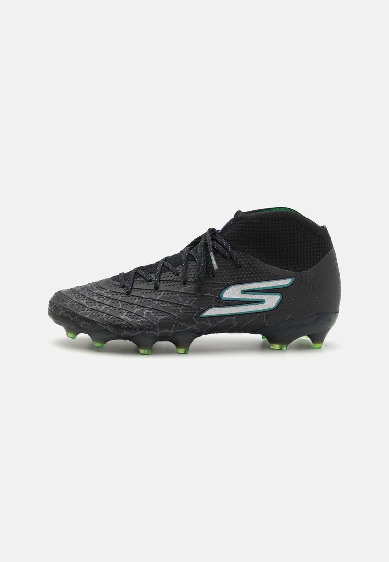 Black soccer cleat with textured surface, green studs, and black mesh ankle support featuring a reflective logo accent.