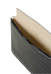 Glossy black crocodile-embossed leather clutch with beige suede interior, open top, and subtle gold brand logo at bottom corner.