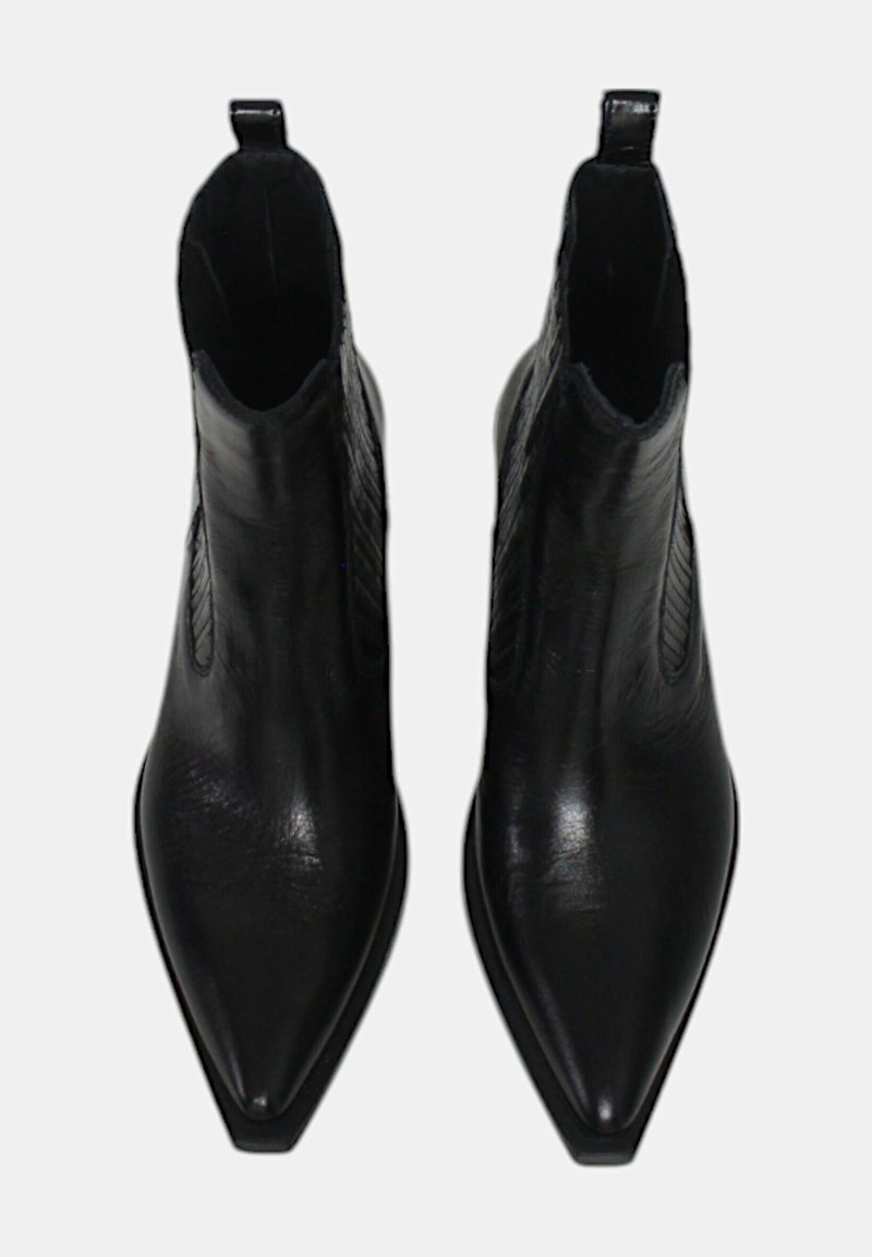 Para czarnych skórzanych botków za kostkę z szpiczastym noskiem, z uchwytami do zakładania i elastycznymi bokami, widziana z góry na białym tle.