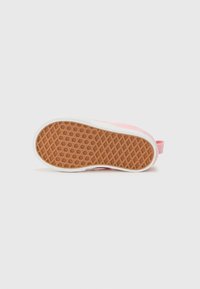 Roze canvas sneaker met een gestructureerde rubberen zool. De zool heeft een honingraatpatroon en een witte tussenzool. Er zit een trekband op de hiel.