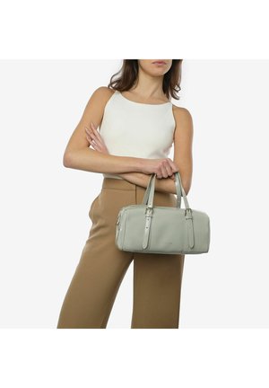 Light grey leather handbag with dual flat handles, rectangular shape, and two zippered compartments. Model wears a sleeveless top and pants.