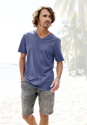 V-neck, short-sleeve t-shirt in solid light purple fabric, paired with gray denim shorts featuring a faded pattern and pockets.