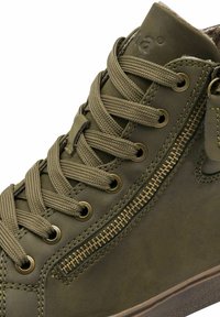 Olive green high-top shoe made of smooth leather, features round laces, a decorative zipper, and a textured rubber sole.