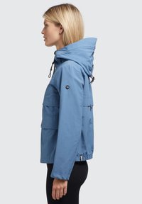 Light blue jacket with a hood, made from smooth fabric. Featuring adjustable drawstrings, two front pockets, and a fitted waist.