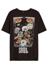 Mustat puuvillapaitat, joissa on valkoinen, oranssi ja vihreä kukkakuosisuunnittelu, sekä teksti "ELECTRIC SOUL" alaosassa.