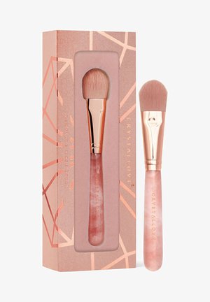 Makeup brush with a pink handle and soft bristles, packaged in a rose gold geometric-patterned box with the brand name "CRYSTALLOVE."