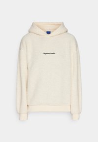 Hoodie in pile color crema con superficie testurizzata, caratterizzato da un logo nero "Originals Studio" sul petto e polsini e orlo a costine.
