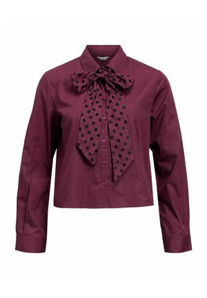 Vīna sarkana īsā krekla ar polka punktu kaklasaiti, garām piedurknēm, ar pogām aiztaisāms priekšpuse un gluda kokvilnas auduma.