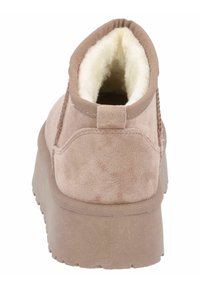 Bottine rose brûlé avec une doublure douce et fourrure, texture en daim, partie arrière arrondie et semelle épaisse et texturée. Dispose d'une petite languette.