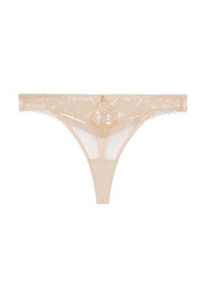 String en dentelle de couleur nude avec motif floral, bords festonnés et un petit détail doré à l'avant.