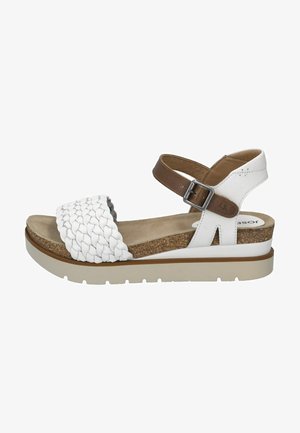 White leather sandal with woven strap detail, brown ankle strap, cork footbed, and a white rubber sole with a slight wedge.