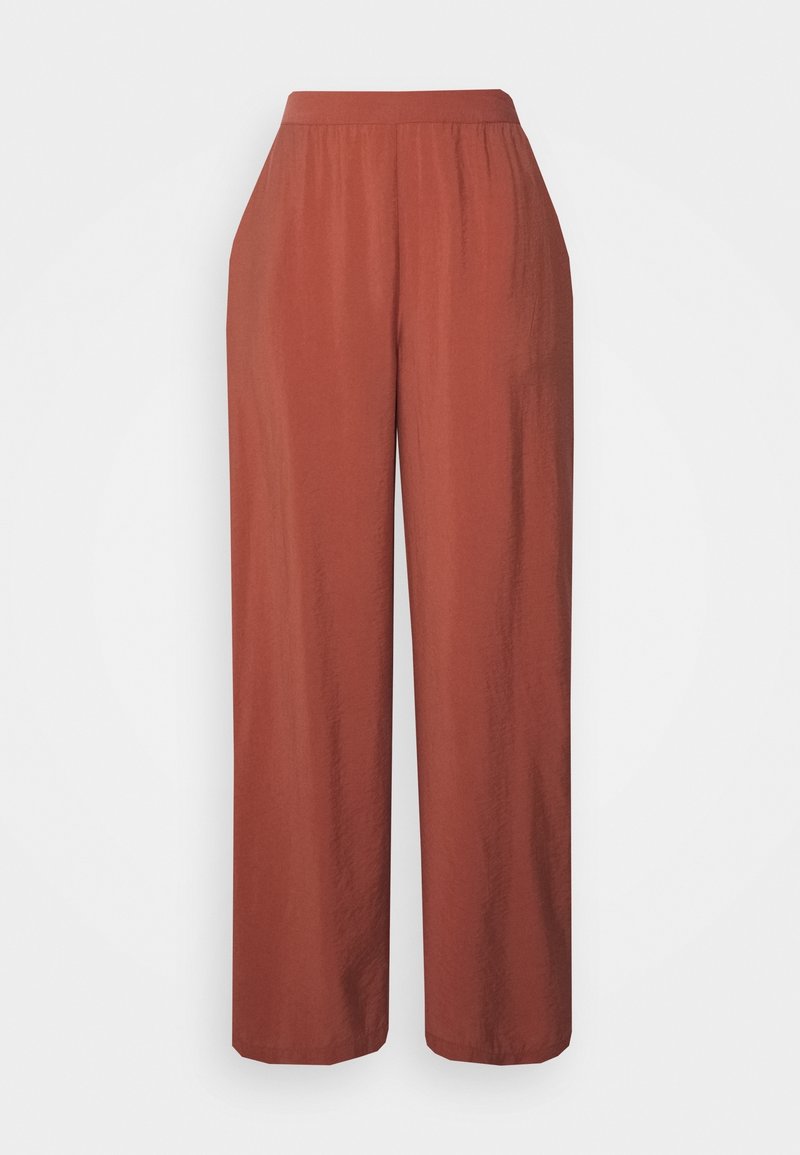 Pantalon taille haute, coupe ample, jambes larges, couleur rouille, avec une ceinture élastique et une texture de tissu lisse.