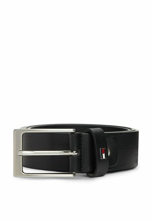 Ceinture en cuir noir roulée avec boucle métallique argentée rectangulaire et petit logo rouge, blanc et bleu sur la boucle de ceinture.