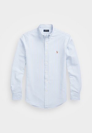 Light blue and white striped button-up shirt with a collared neck, long sleeves, and a small embroidered logo on the chest. Cotton material.