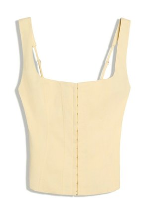 Top corset sans manches jaune clair avec encolure carrée, fermeture avant verticale à agrafes et bretelles réglables.