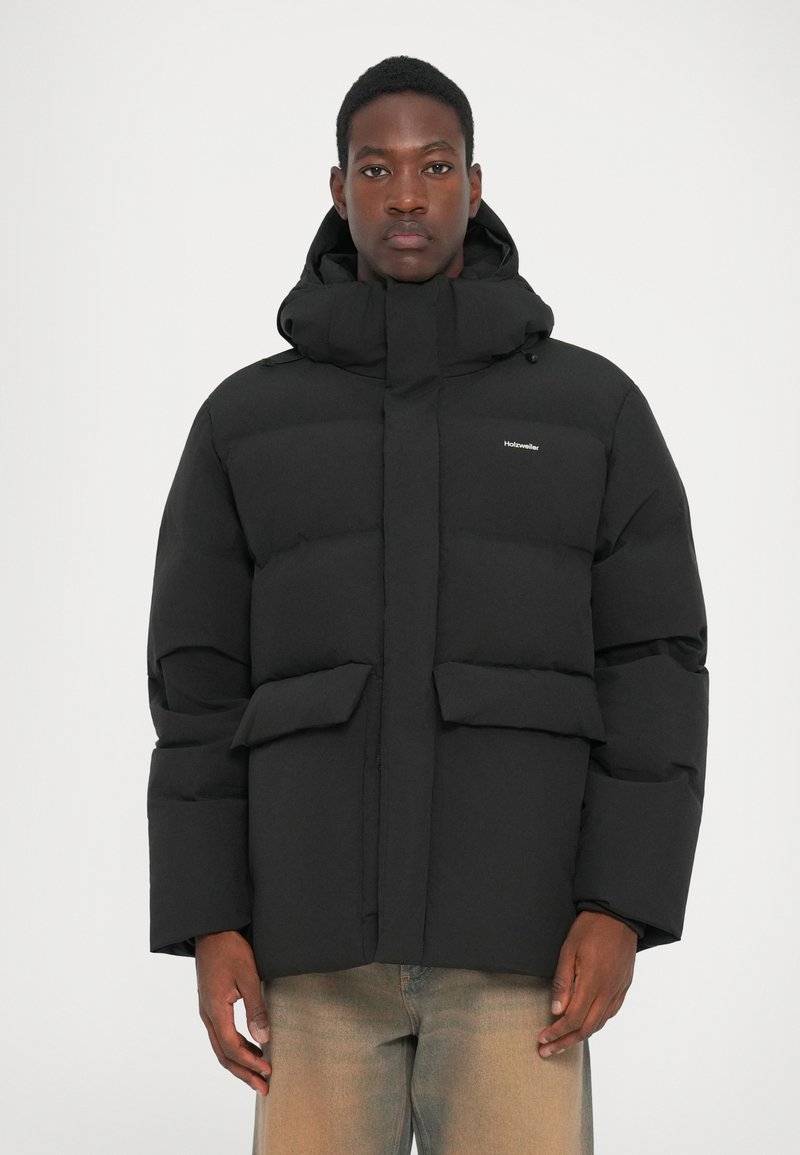 Black puffer jacket with a hood, featuring a zip front, two large front pockets, and a logo on the chest. Smooth, insulated texture.