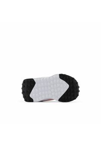 Shoe sole with a white center featuring circular patterns and a black outer rim with raised studs; designed for traction and stability.