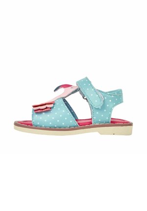 Sandale enfant bleue à pois avec décoration flamant rose, fermeture à velcro, semelle intérieure rouge et semelle beige.