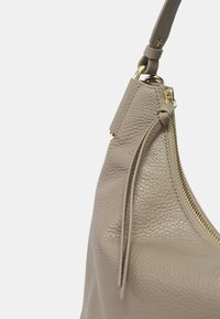 Borsa a tracolla in pelle grigia con finitura testurizzata e dettagli in zip dorata. Caratterizzata da una tracolla sottile e un tassello decorativo vicino alla zip.