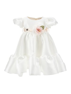 White satin dress with puff sleeves, ruffled hem, and a pink flower accent at the waist. Back zipper closure. Smooth, shiny texture.