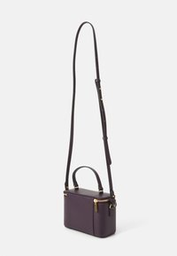 Purple leather crossbody bag with a detachable strap, top handle, gold hardware, rectangular shape, and textured exterior.