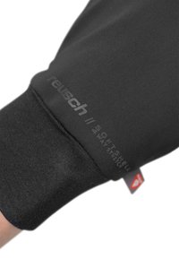 Black softshell glove featuring a snug fit, elastic cuff, and embossed "reusch" logo with "SOFTSHELL 4-WAY STRETCH" text.