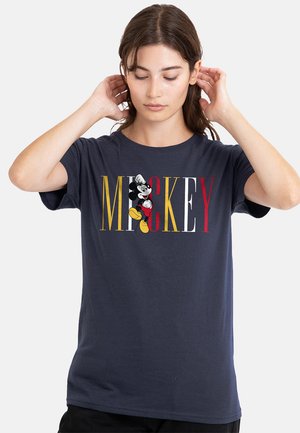 Navy blue cotton t-shirt featuring "MICKEY" in bold yellow, red, and white letters. A black and white Mickey Mouse graphic is included.