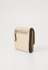 Folded wallet in cream and soft pink leather with gold zip closure, textured surface, and side tab for easy handling.