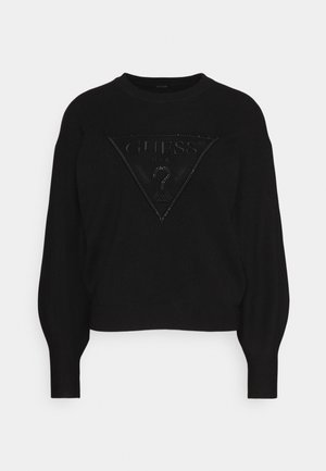 Pull noir à manches longues avec manches bouffantes, présentant un triangle du logo Guess embossé en noir avec un point d'interrogation sur le devant.