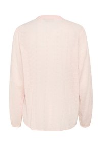 Blouse longue à manches longues rose clair en tissu texturé avec de petits motifs découpés et un col rond. La vue de dos montre une couture centrée.