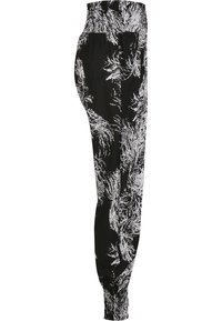Zwarte joggers met een wit abstract patroon, elastische tailleband en boorden. Gemaakt van zachte stof met een ontspannen pasvorm.