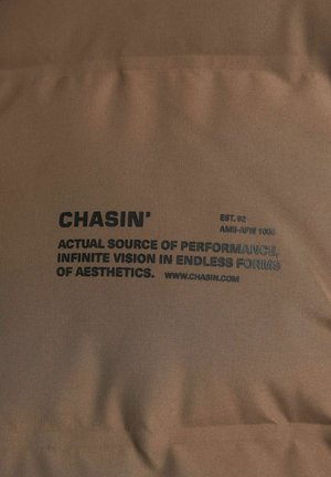Brown fabric featuring bold black text: "CHASIN', EST. 92, ACTUAL SOURCE OF PERFORMANCE, INFINITE VISION IN ENDLESS FORMS, www.chasin.com."