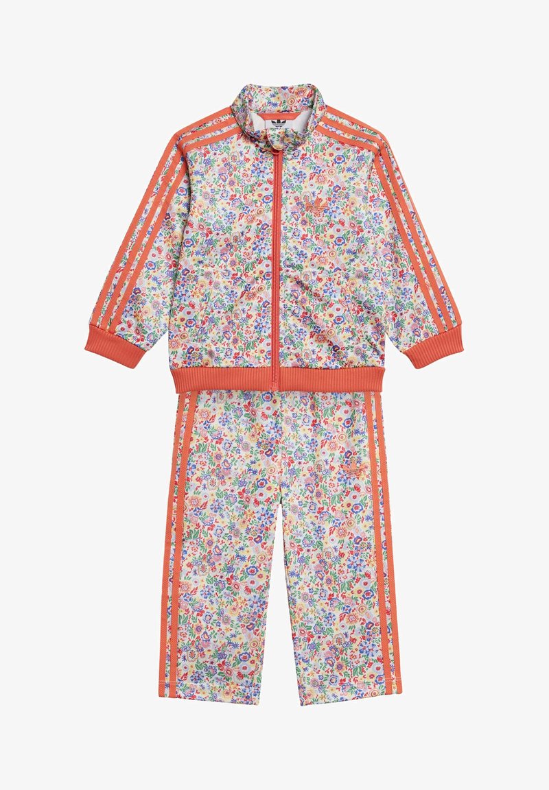 Floral tracksuit in pastel colors, featuring a zip-up jacket with orange stripes and matching pants. Made of lightweight fabric with ribbed trim.
