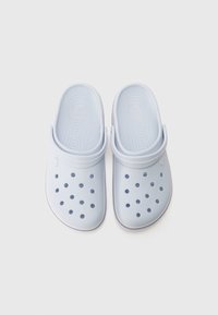 Light blue clogs with a rounded shape, made of synthetic material. Features ventilation holes and a strap across the heel. Flat sole.