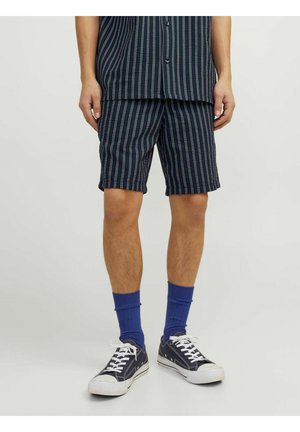 Navy striped shorts made of woven fabric, featuring a relaxed fit, above-the-knee length, and a flat front design. Paired with blue socks and sneakers.