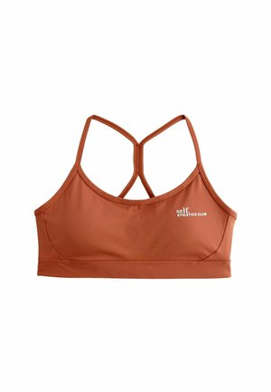 Reggiseno sportivo color mattone realizzato in tessuto liscio e elasticizzato; presenta un design a corsetto e un piccolo logo bianco sul lato sinistro.