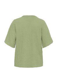 Light green short-sleeve top made of textured fabric, featuring a relaxed fit and a round neckline with no visible fastenings.