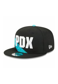 Black snapback cap features white "PDX" lettering, blue geometric accents, and a flat brim. Includes a branded logo on the side.