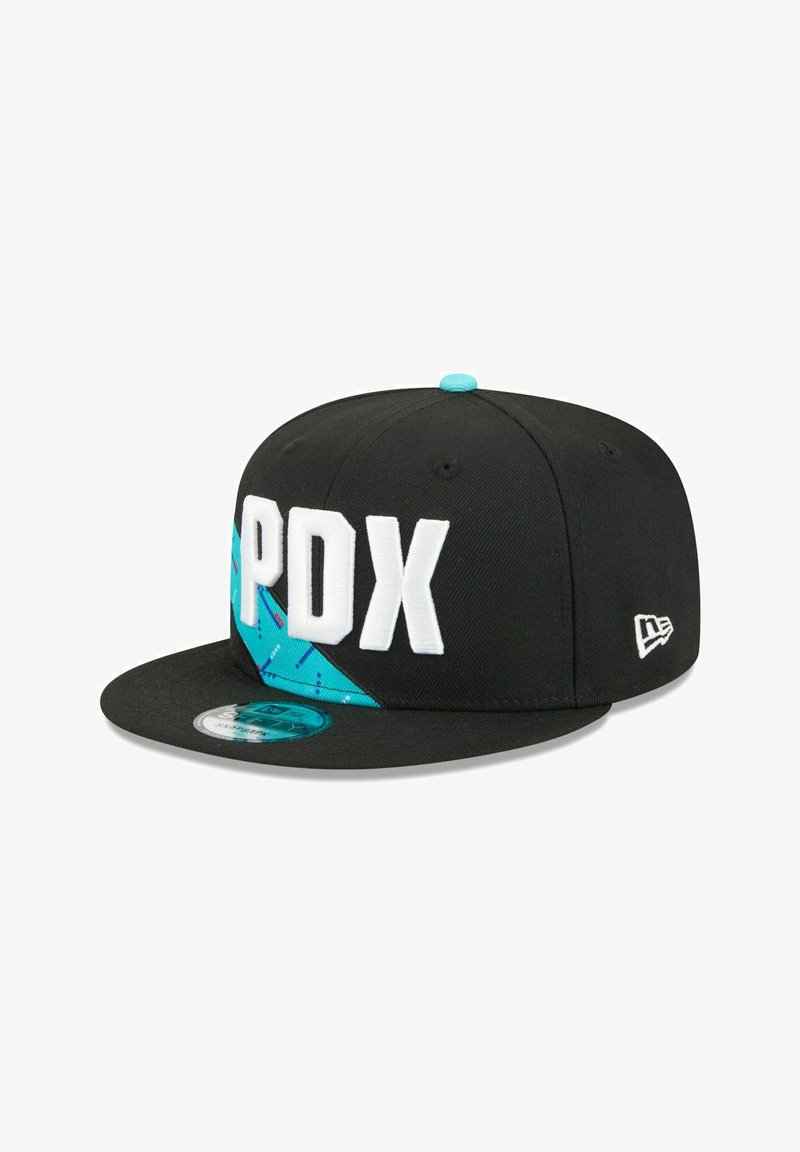 Black snapback cap features white "PDX" lettering, blue geometric accents, and a flat brim. Includes a branded logo on the side.