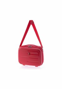 Compact red hard-shell shoulder bag with adjustable strap, zipper closure, and textured horizontal lines on front panel.