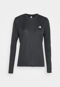 Musta pitkähihainen urheilu-paita, joka on valmistettu sileästä ja kevyestä kankaasta, jossa on pyöreä kaula-aukko ja pieni valkoinen logo vasemmassa rinnassa.