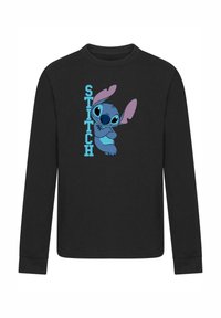 Čierna košeľa s dlhým rukávom, na ktorej sa nachádza modrá kreslená postavička s veľkými ušami a očami, spolu so slovom "STITCH" vo svetlomodrej.