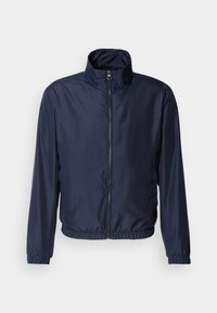 Navy blue lightweight jacket with a stand collar, front zipper closure, elastic cuffs, and hem; smooth texture, minimalist design.